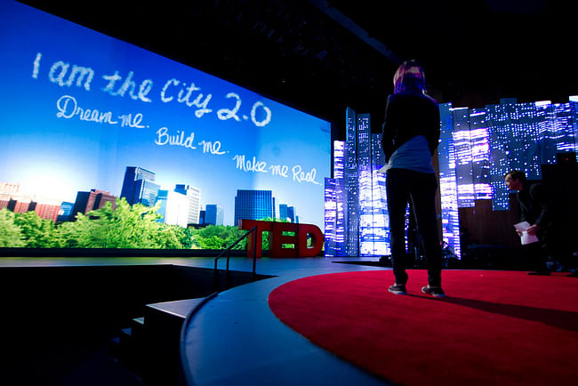 TED’s Amy Novogratz watches the video play onstage at TED2012 (Photo: James Duncan Davidson)