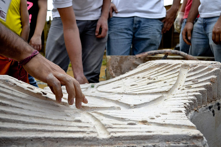 Students playing with some marble on the built prototype