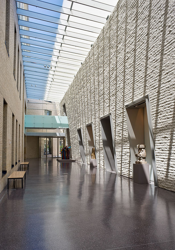 Skylit Galleria. The texture of the rustic-faced, concrete block complements the brick masonry on the existing building’s rear facade.