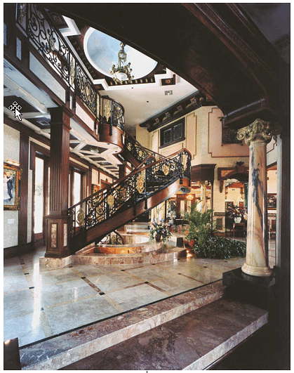 Cantilevered main stair and upper bridge. Italian marble floors, Chinese column shafts.