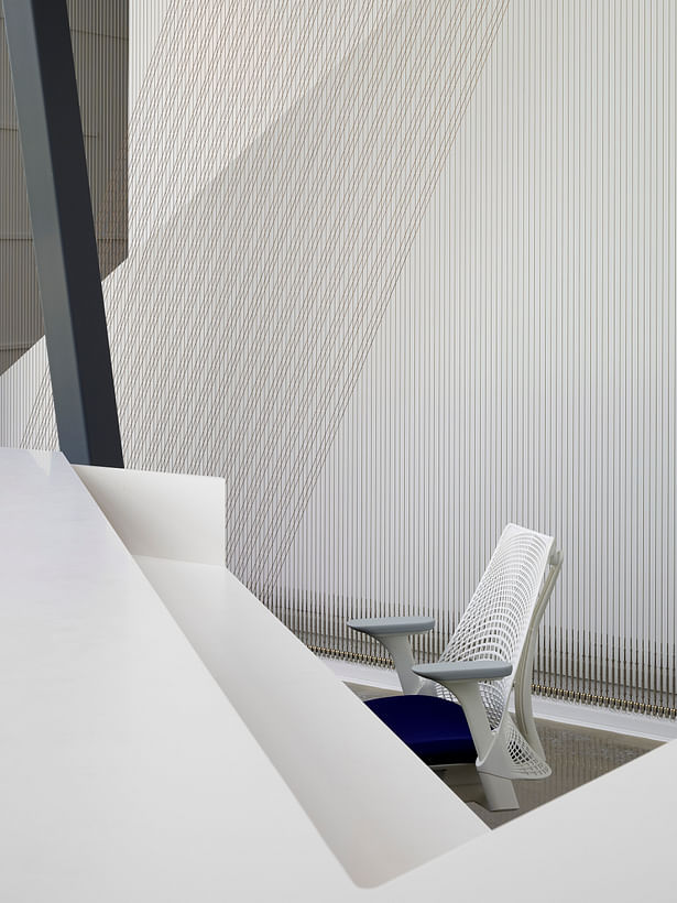 No detail is without opportunity. The moiré cable wall, structural members, and Sayl Chair from Herman Miller relate to one another. 