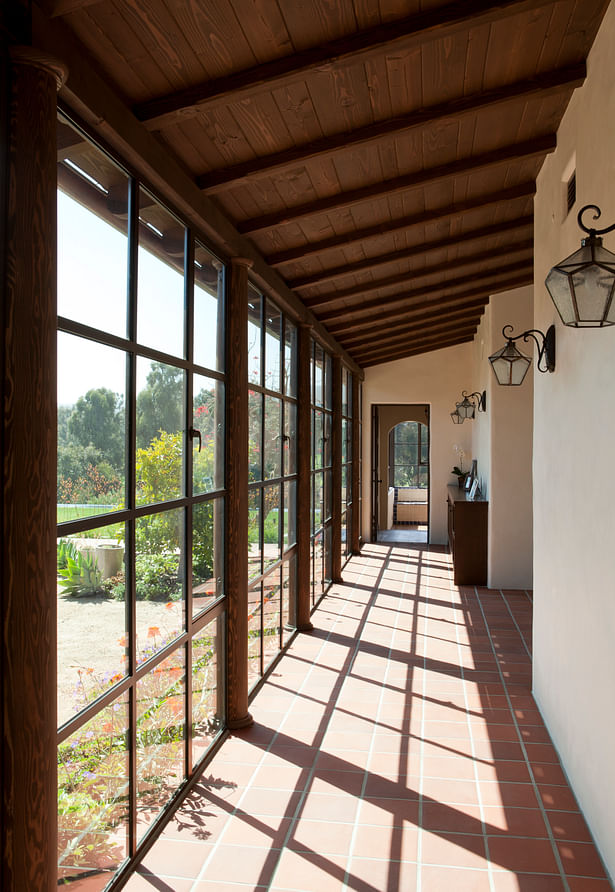 A glassed-in walkway leads to the master suite.