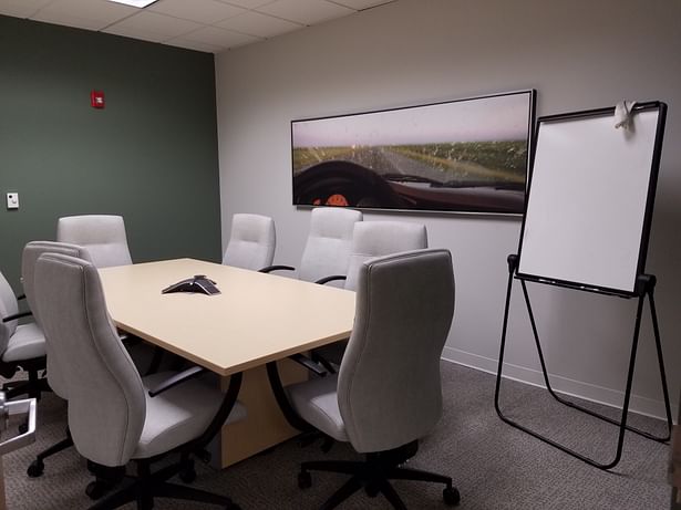 Small Conference room with end walls painted with Benjamin Moore's 'Lush' plus new artwork.