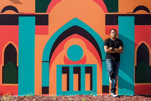 Architect/artist/city planner Germane Barnes in front of the Opa-Locka Community Development Corporation's Arts & Recreation Center. Mural by Lekan Jeyifo. Photo: Matthew Roy, via Curbed.