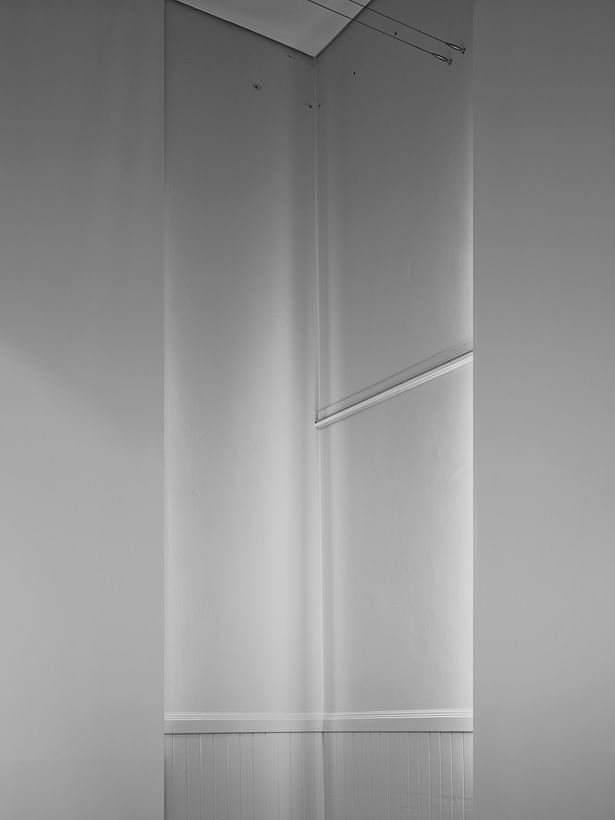 Two blackout shades create a unique corner condition. The reflected light illuminates a corner in a ghostly way. 