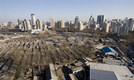 Skyscrapers and modern buildings stand behind a traditional Chinese housing complex in Beijing. Photograph: Diego Azubel/EPA, via theguardian.com