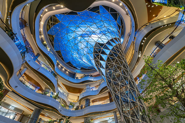 A cascading funnel in the main atrium, serving as a canvas for a 360-degree light show