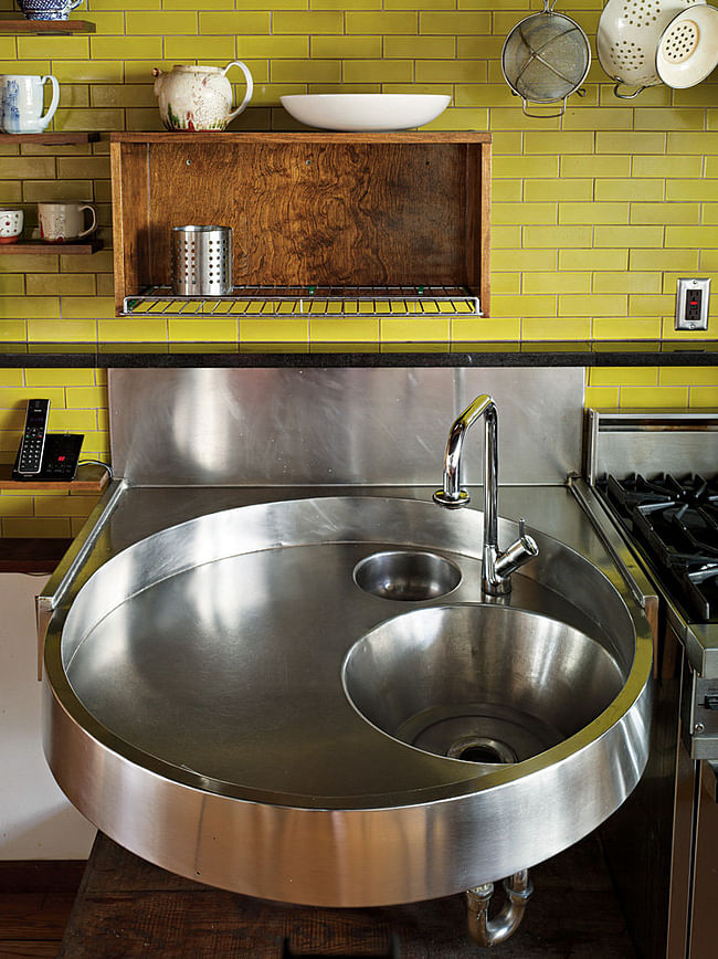 Her custom stainless steel kitchen sink, which is inset with a mixing bowl and bucket. Annie Schlechter