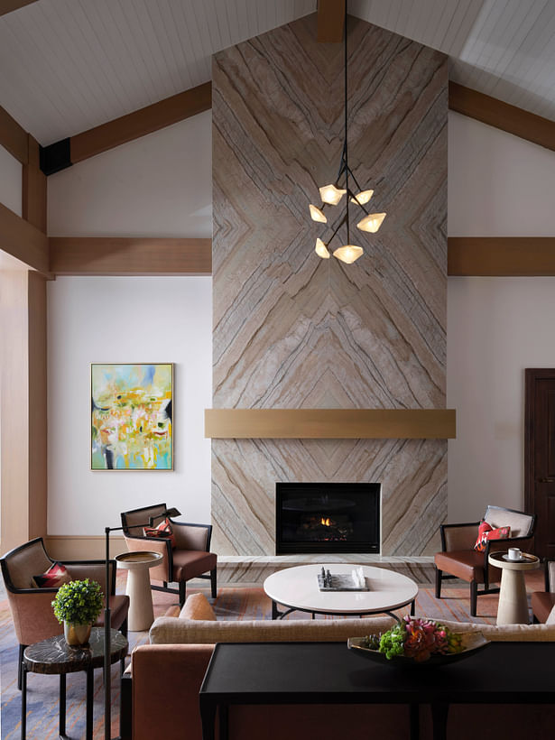 A fireplace clad in bookmatched stone lends a cozy feel to the living room. (photo by Will Pryce)