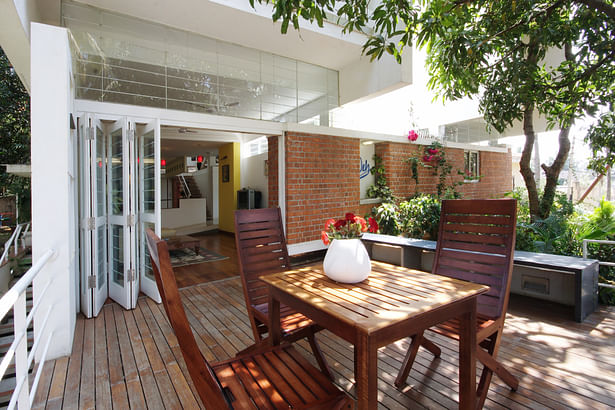 Deck opening out from the living room with the back wall relenting