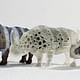 A zebra-like textured rhino with spiky skin, a porous rhino and an opaque rhino with a transparent shell 3D printed with a multi-material printer. Courtesy of MIT Computational Fabrication Group.