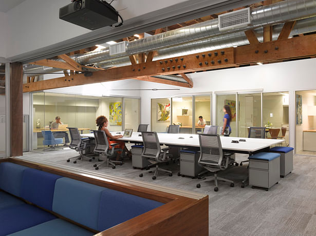 Shared desks with private offices in the background