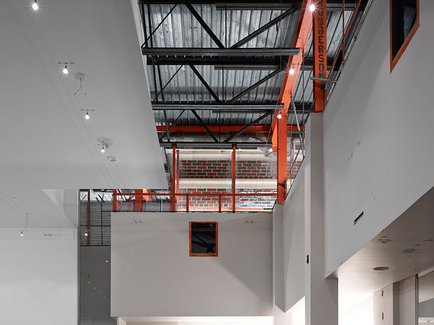 We chose to expose the intersection of the original 1933 building and the 1960s addition. The uplighting of the orange steel and exposed structure celebrates the history and the future. 