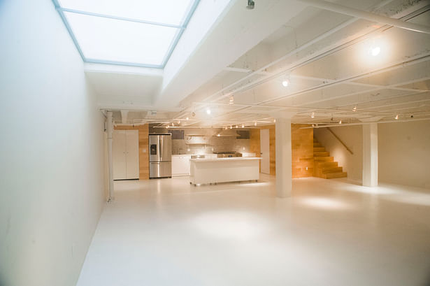 The renovated basement apartment with one of two skylights seen above.