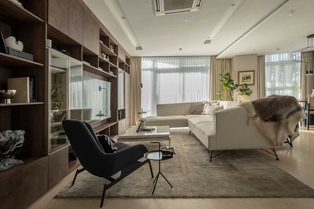 Sophisticated interiors with a variety of white textures and a full wall entertainment center 