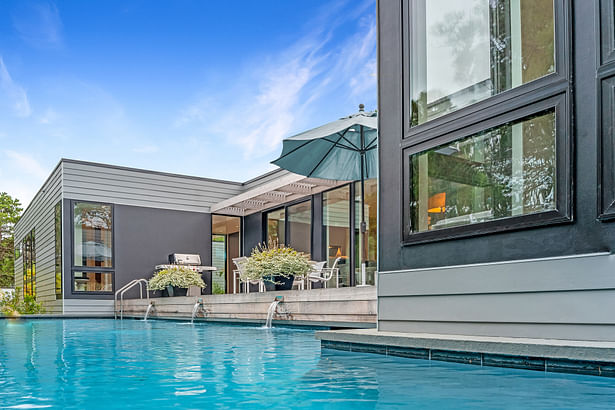 The dining deck off the living space looks past the pool to the dunes. Credit: Brian Bailey