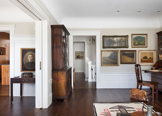 On the upper floor, the entry hall, formal living room and dining room at the front of the house maintain their authentic character and detailing, albeit brighter through the painting of dark wood with lighter hues.