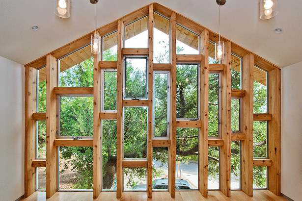 The window wall, high above the street and screened behind the oak tree for privacy.