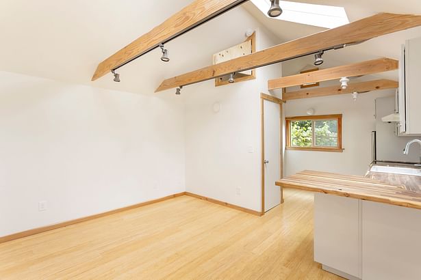 Living space after, looking towards kitchen. Photo by Living Room Realty.