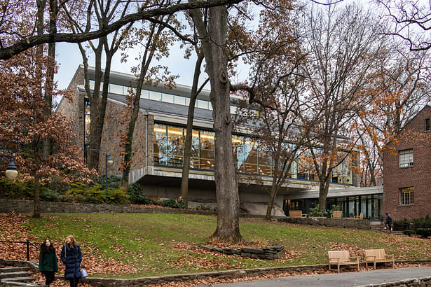 Maintaining the integrity of the original stone and concrete building, the exterior renovation includes new windows with “bird-friendly” glazing and a new main entrance facing the campus quadrangle. © James Ewing