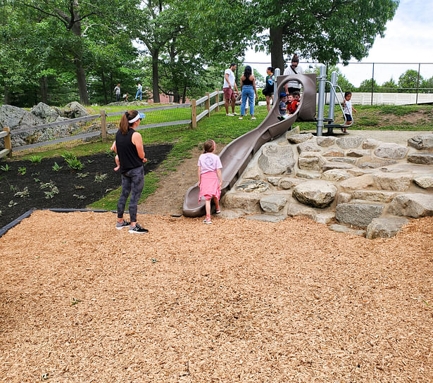 Kids playing on the large embankment slide.