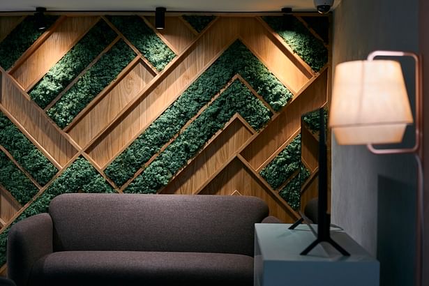 Feature moss and oak wall with subtle lighting - entrance lobby