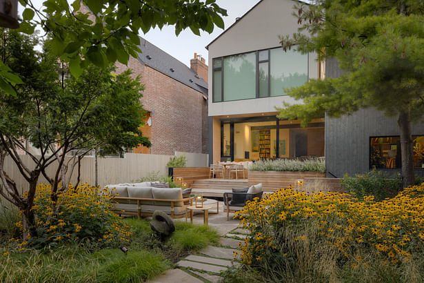 Approach to the patio through the carpet of grasses and perennials