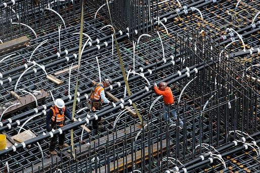 Workers position pipes in the 18-foot-deep pit that will be filled with concrete to form the foundation for the New Wilshire Grand skyscraper at 7th, Wilshire and Figueroa. For the tallest structure to be built west of the Mississippi, the concrete will be poured without interruption. (Mel Melcon...