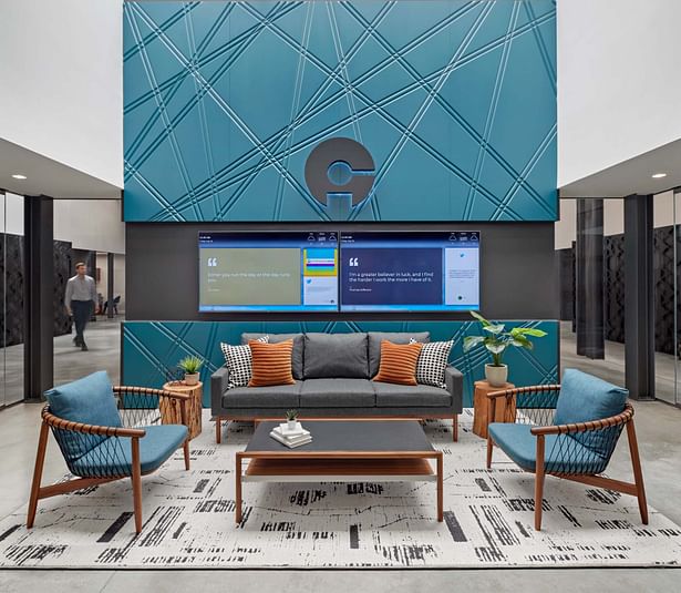 An ever-changing monitor, mounted on a floor-to-ceiling engraved feature wall at the main entrance, allows Connecticut Innovations to showcase its own brand and promote tech partners.