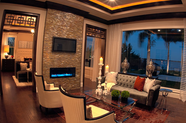 Master suite sitting room retreat with ribbon fireplace and lake view