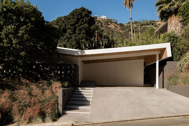 'An original butterfly roof defines the midcentury structure, which is sited on a winding street above the Sunset Strip in Hollywood. Standard Architecture retained this core geometric feature, adding cedar siding underneath overhangs and white edges to emphasize the lines.'