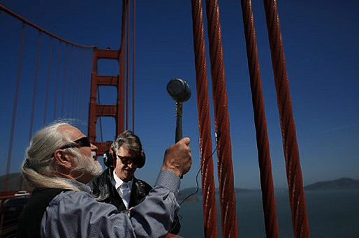 Doug McKechnie (left) and Paul de Benedictis of the S.F. Synthesizer Ensemble record the tones produced by striking different parts of the Golden Gate Bridge with a rubber mallet earlier this month. 
