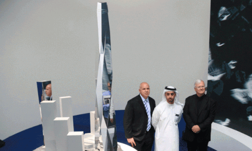 Gordon Gill and Adrian Smith standing with their client next to a model of the massive Burj 2020 district, which was revealed in Dubai this week. (Image via MEConstructionNews.com)