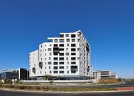 Off-white, sculpted monolithic apartment block by dhk features terracing crescendo