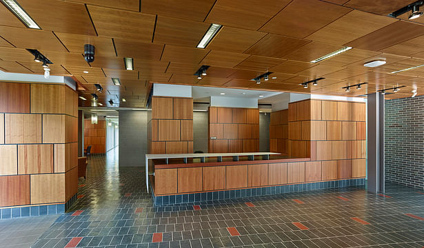 Waiting, reception, and public spaces all have a family of materials; pecan paneling, ground face masonry, and natural slate.