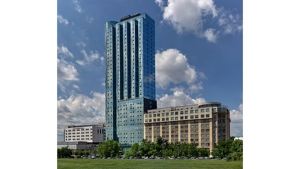 This signature transit-oriented mixed-use multifamily maximizes views of Lower Manhattan by creating setbacks on the upper levels giving each unit a window facing the World Trade Center. The 12-story base matches the height of the adjacent buildings and then the amenity floor sets back to reveal a clear distinction between the base and tower.