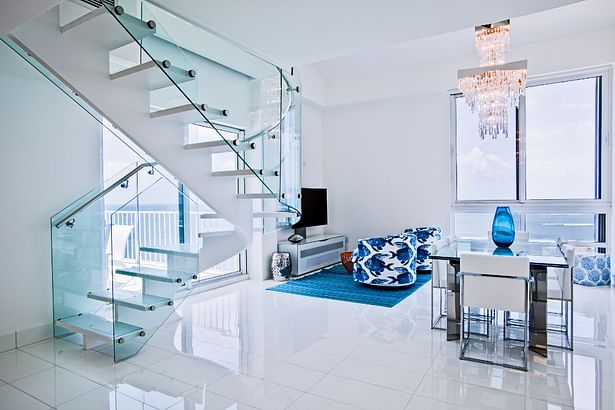 Curved glass railings and chrome stainless steel helped this space look light and airy