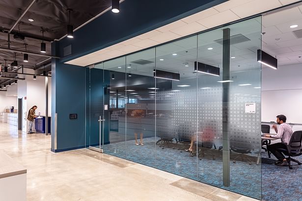 The medium conference room is designed to feel like a part of the larger space while at the same time being distinctly separate.