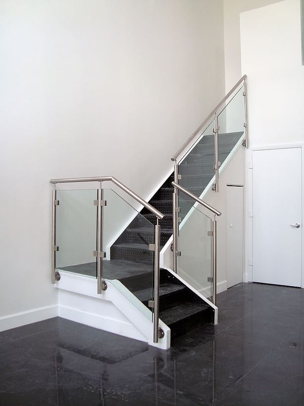 Glass railings, stainless steel side-mounted posts, & top mounted stainless steel handrails