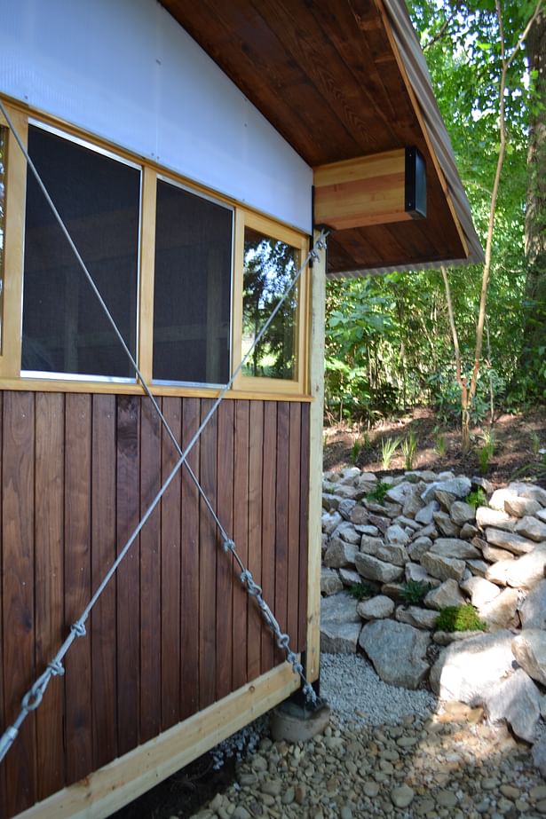 Detail of bracing, custom built windows, polygal siding, and refinished walnut siding.