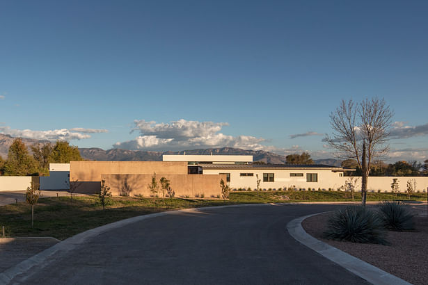 Entry side of house, with orchard in foreground. Image: Robert Reck