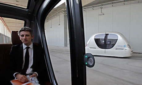 Plodding pods ... driverless vehicles pass by each other in Masdar City, Abu Dhabi – but it might be quicker to walk. Photograph: Kamran Jebreili/AP