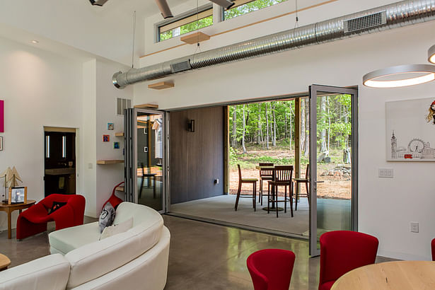 Folding glass doors open the center of the house to the back porch and the natural environmental. 