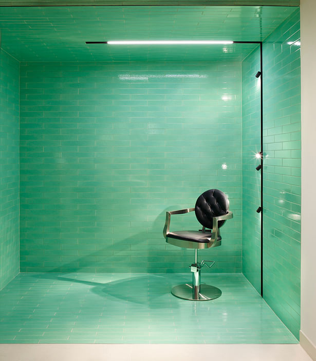 Green tiling is complemented by sleek lighting