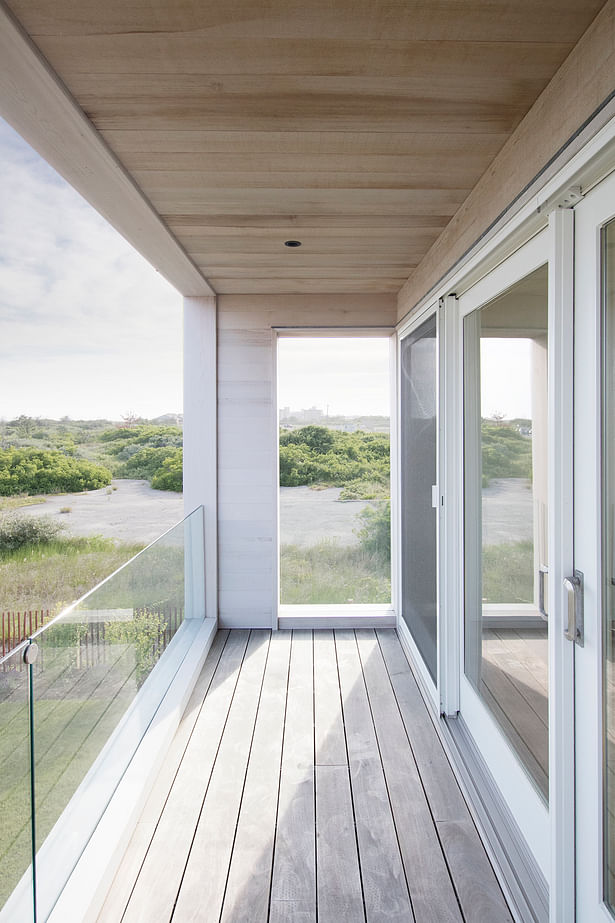 A small covered deck off the office provides dune and water views