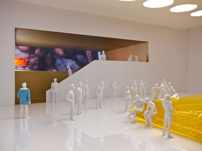 The Man in the Blue Coat walks through the gallery displaying a Gelatin special exhibit.