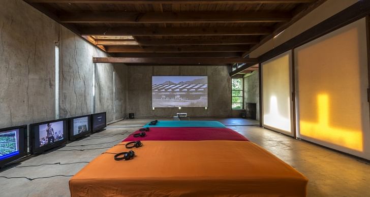 A view of one of the rooms in the Schindler House activated by Green's installation. In this room, a large projection and several videos on small screens are on view. The large projection is an ongoing work: its final iteration will be screened on Wednesday in Los Angeles. Courtesy the artist...