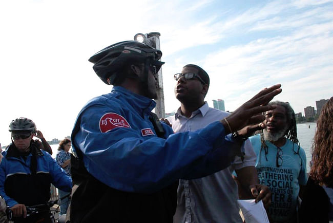 Private security guards attempting to remove demonstrators for water rights from the Detroit RiverWalk, a public space managed by Detroit RiverFront Conservancy. (Courtesy Detroit Resists)