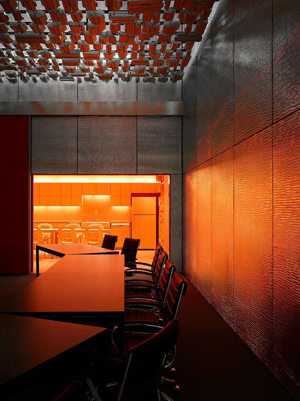 The training room palette of materials includes recycled toner cartridges suspended from the structure. Aluminum bubble wrap provides a glistening wall surface. 30’ wide sliding doors separate the training room from the café.