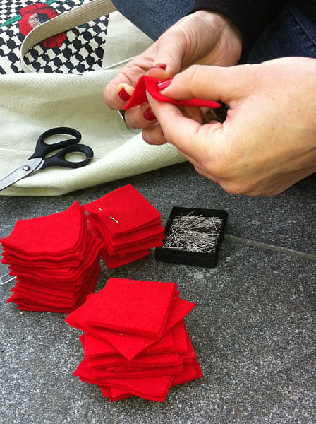 Protesters making red felt squares in Montreal. Credit: the Village Voice